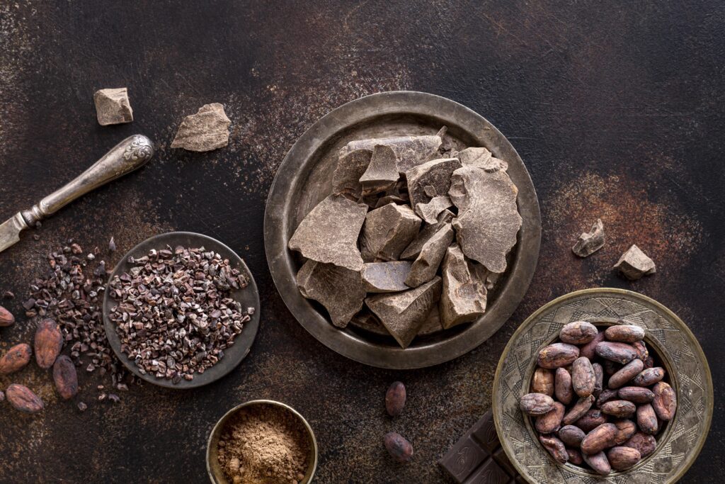 flat-lay-chocolate-chunks-plate-with-cocoa-powder-beans